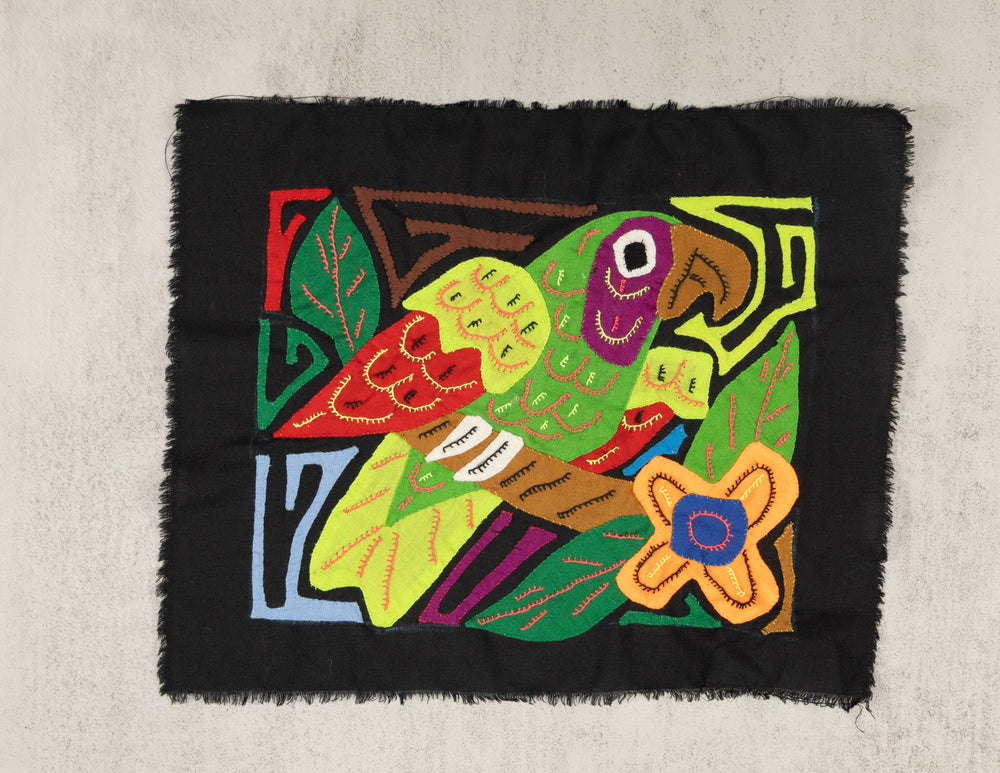 Panama molita, a white crowned parrot with a red wing on black, hand stitched reverse applique