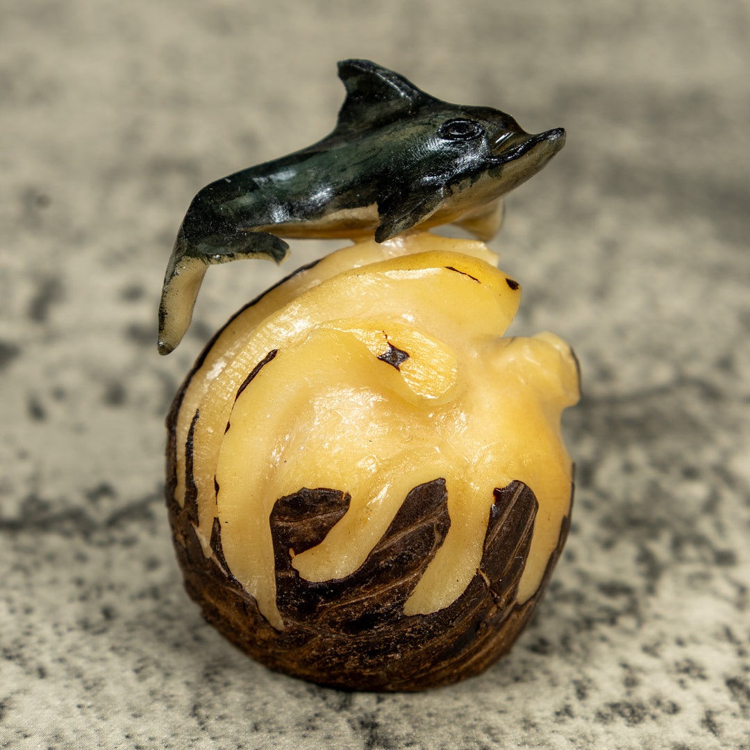 Black And Gray Dolphin Riding Waves Tagua Carving
