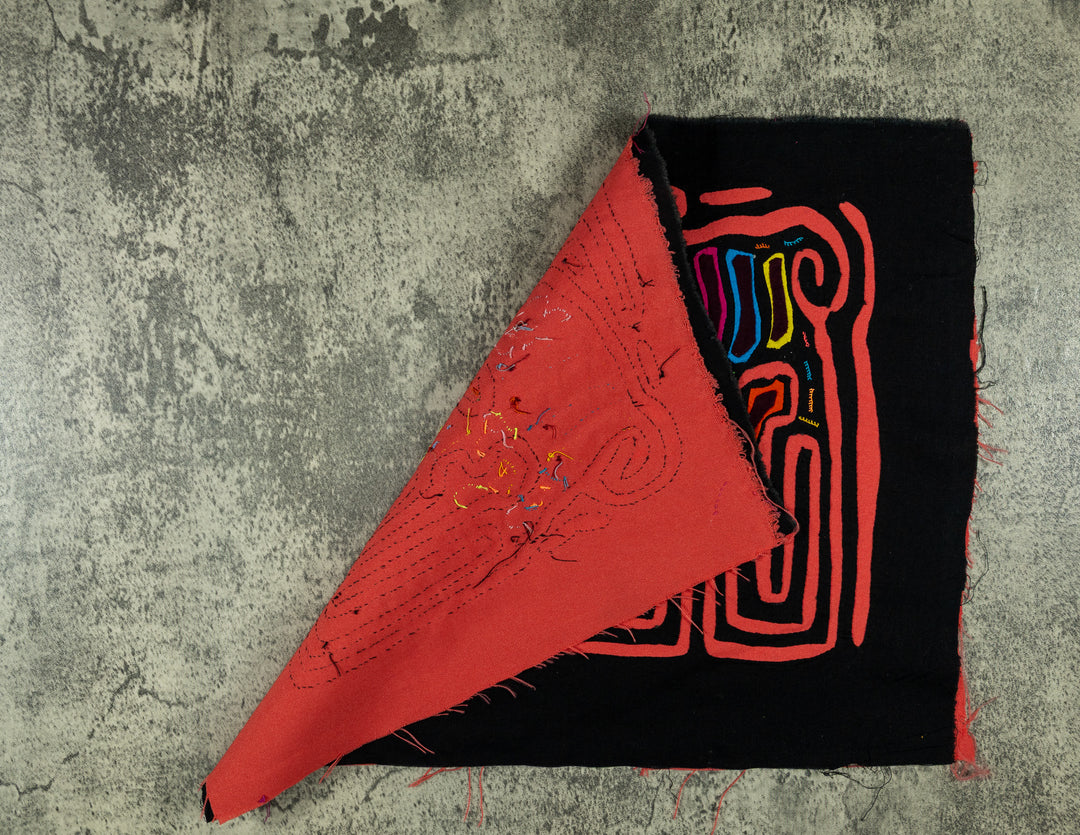 Hand stitched Guna mola from Guna Yala Panama, coral orange outline framing the two critters