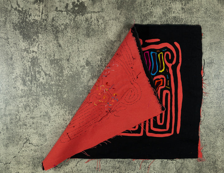 Hand stitched Guna mola from Guna Yala Panama, coral orange outline framing the two critters