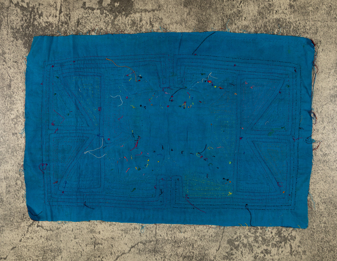Jungle joker crouched in a maze mola, hand stitched Guna panel from Panama, 17 by 11 inches