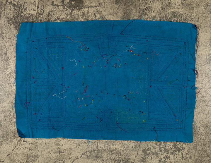 Jungle joker crouched in a maze mola, hand stitched Guna panel from Panama, 17 by 11 inches