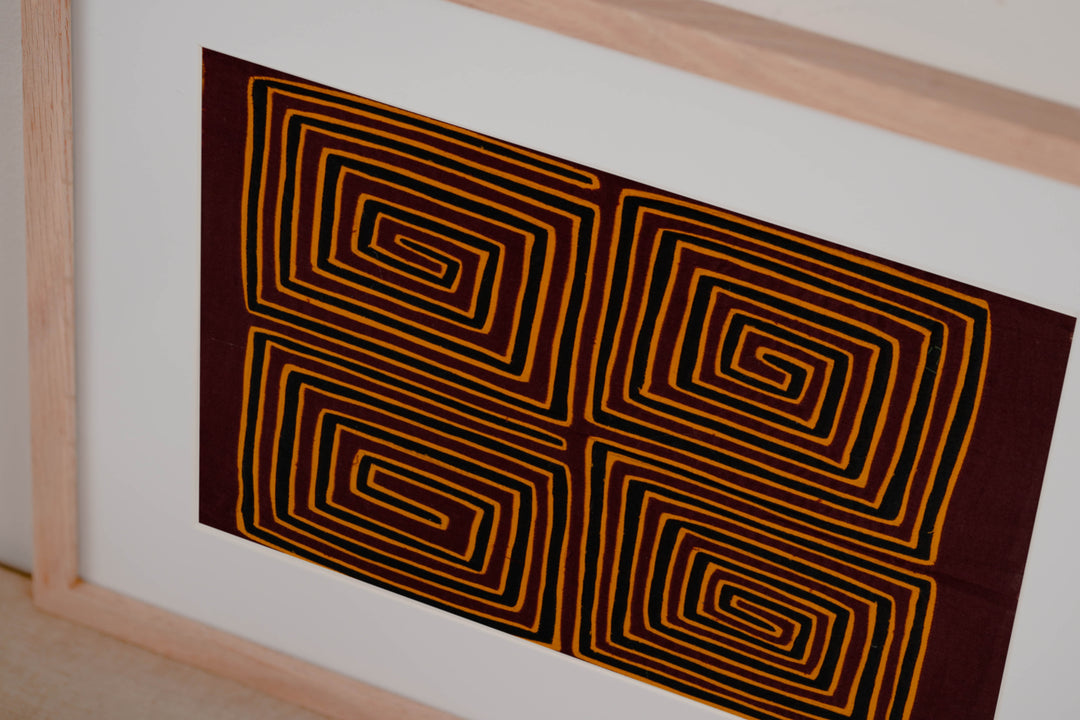 Hand stitched Guna mola from Guna Yala Panama, black accents between the spirals in a neat grid
