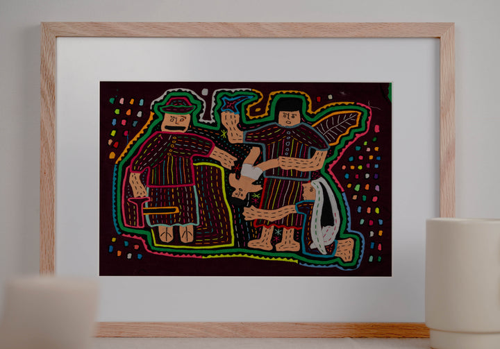 Panama mola panel, nativity figures gathered around the baby Jesus in red and cream, hand stitched reverse applique