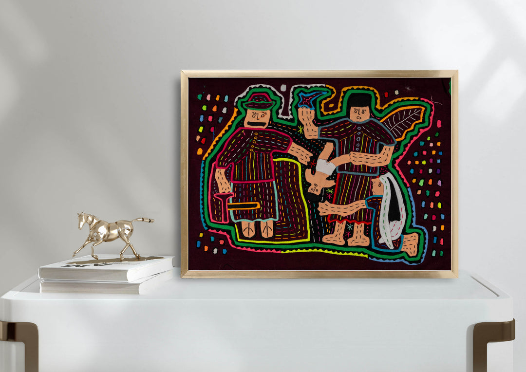 Panama mola panel, nativity figures gathered around the baby Jesus in red and cream, hand stitched reverse applique