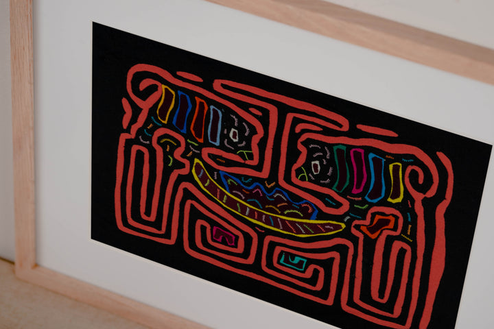 Hand stitched Guna mola from Guna Yala Panama, coral orange outline framing the two critters