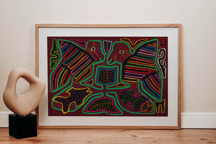 Panama mola panel, two striped wing birds above two fish in green outline on maroon, hand stitched reverse applique