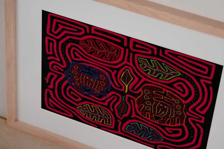 Panama mola panel, two round crabs with stitched shells among leaves in a pink maze on black, hand stitched reverse applique