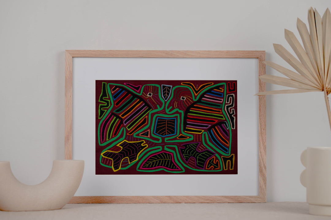 Panama mola panel, two striped wing birds above two fish in green outline on maroon, hand stitched reverse applique