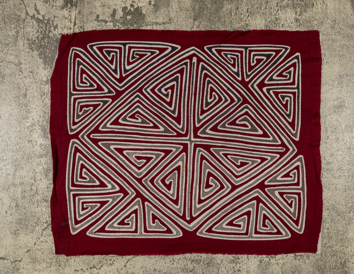 Panama mola panel, gray and white triangle spirals forming an X and diamond on maroon, hand stitched reverse applique