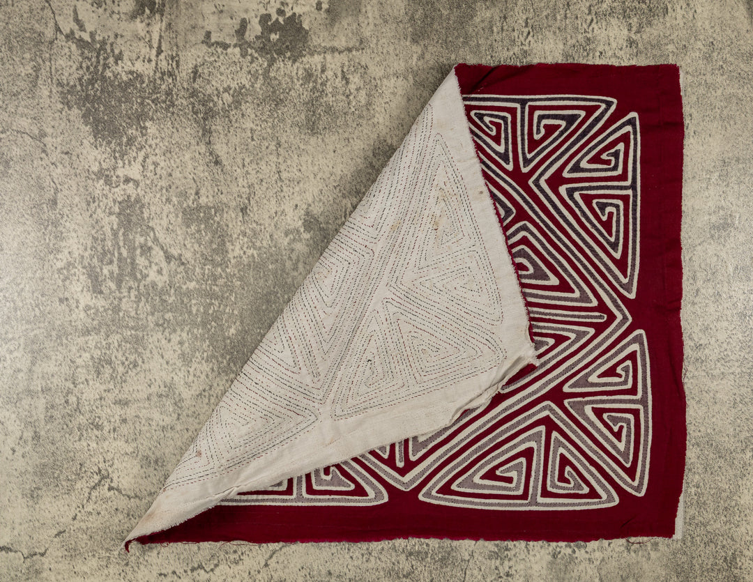 Hand stitched Guna mola from Guna Yala Panama, diamond shape set at the crossing point of the X
