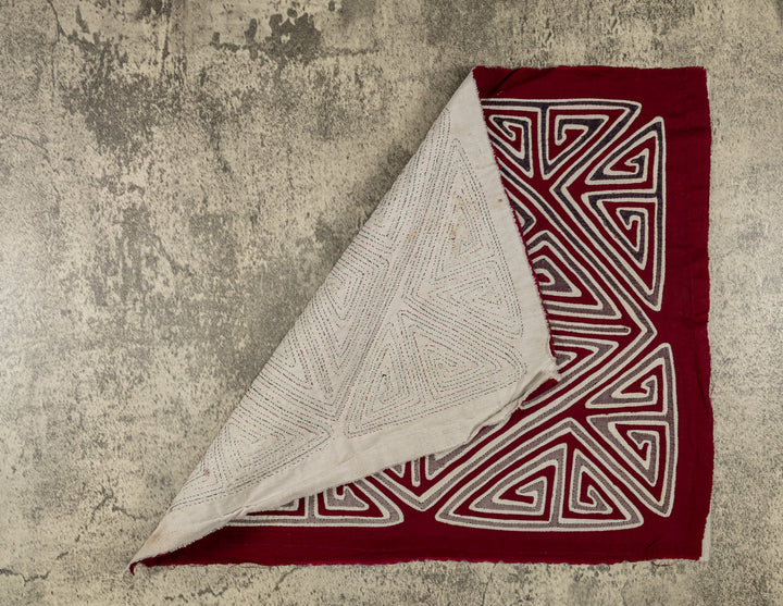 Hand stitched Guna mola from Guna Yala Panama, diamond shape set at the crossing point of the X