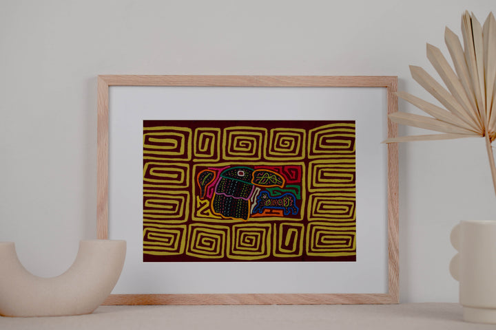 Panama mola panel, toucan beside a small blue critter inside a yellow spiral border, hand stitched reverse applique