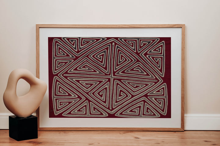 Panama mola panel, gray and white triangle spirals forming an X and diamond on maroon, hand stitched reverse applique