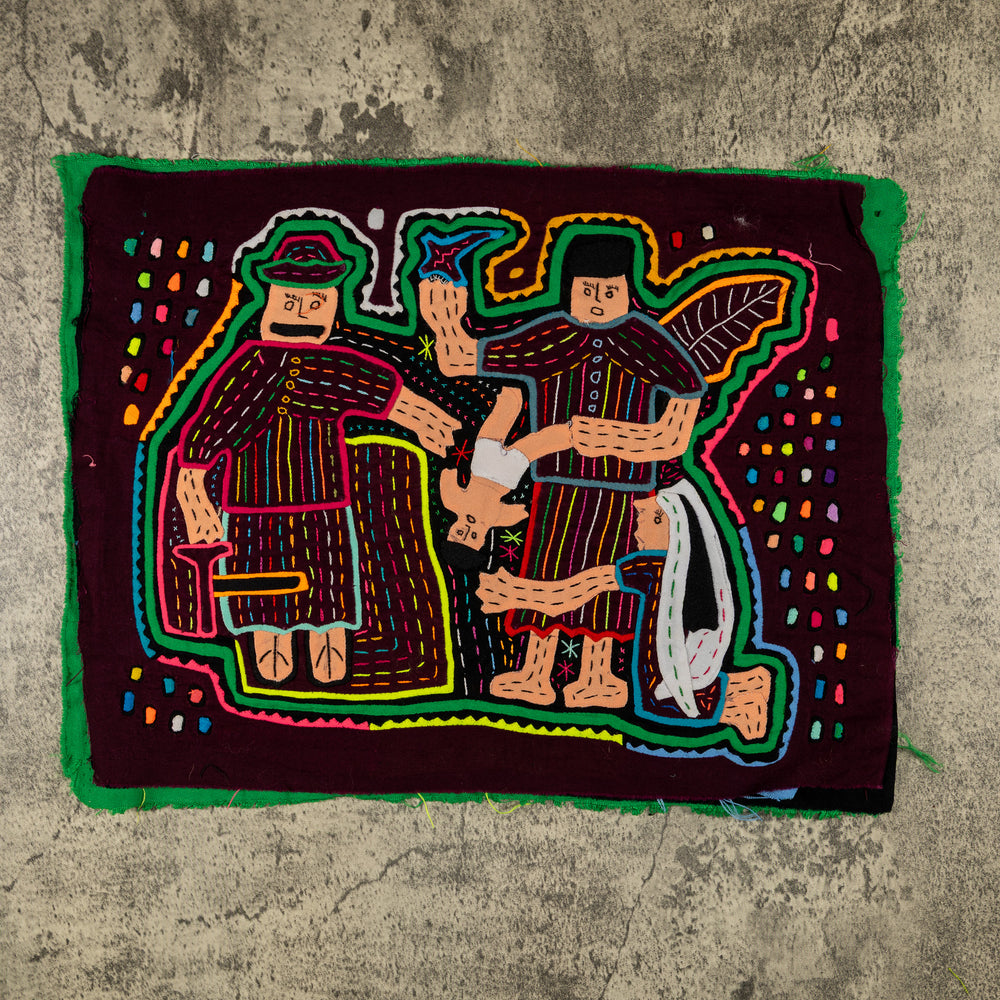 Panama mola panel, nativity figures gathered around the baby Jesus in red and cream, hand stitched reverse applique