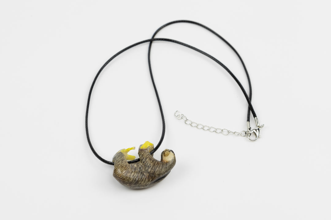 Sloth tagua necklace, grey with yellow details