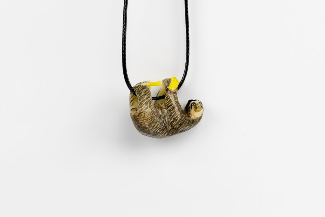 Grey sloth tagua with plants