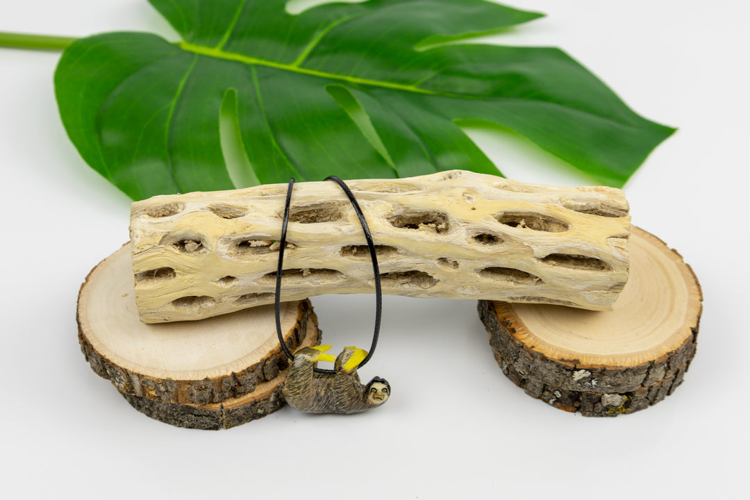 Grey sloth tagua pendant, upside-down pose
