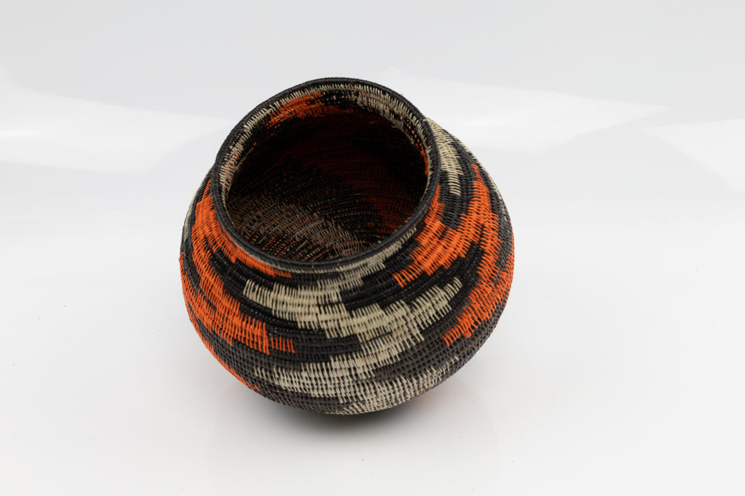 Panama Hand woven black and orange basket. palm fiber. natural dyes.