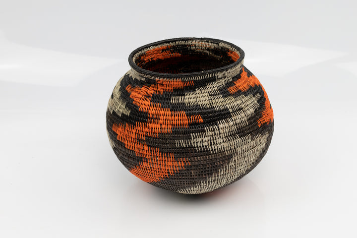 Panama Hand woven black and orange basket. palm fiber. natural dyes.