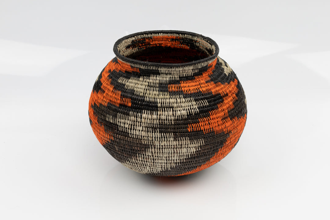 Panama Hand woven black and orange basket. palm fiber. natural dyes.