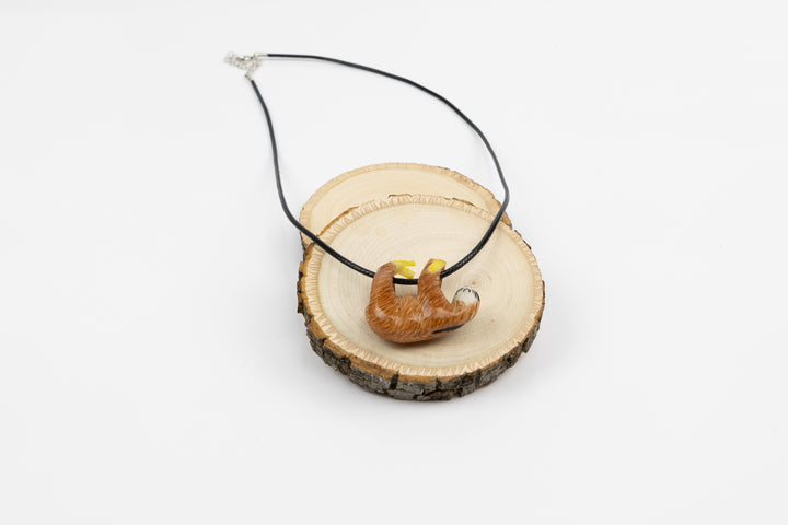 Sloth tagua necklace in packaging