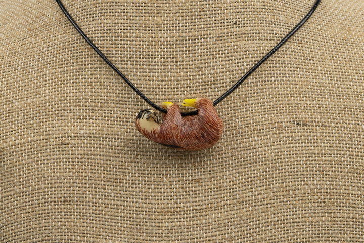 Sloth tagua pendant, orange with yellow markings, flat display