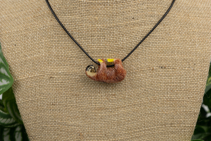 Sloth tagua on wood, tan with yellow details