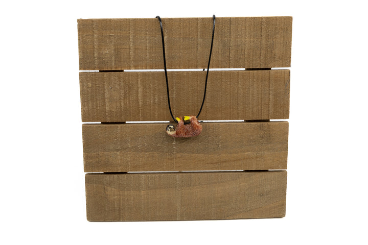 Sloth tagua necklace with green plants