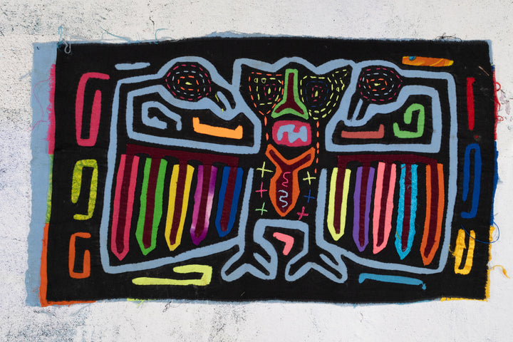 Panama mola panel, central figure with rainbow wings on black, hand stitched reverse applique