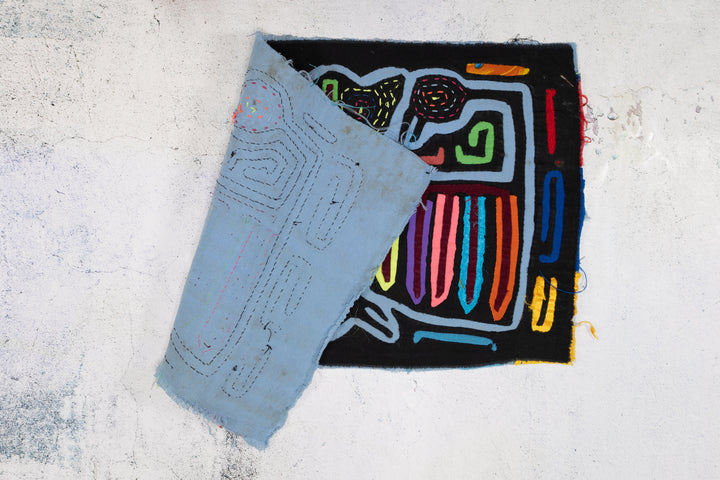 Panama mola panel, central figure with rainbow wings on black, hand stitched reverse applique