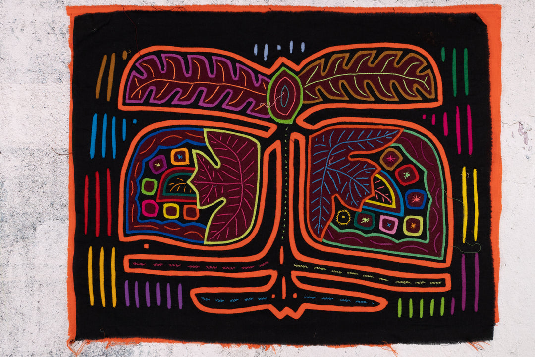 Panama mola panel, orange outlined fronds and veined leaves on black, hand stitched reverse applique