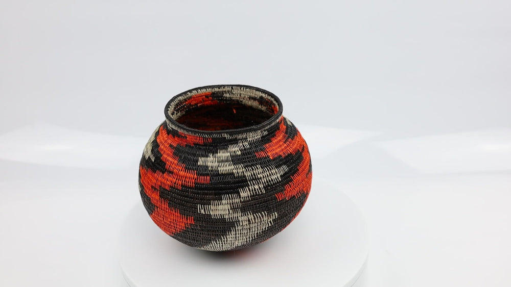 Panama Hand woven black and orange basket. palm fiber. natural dyes.